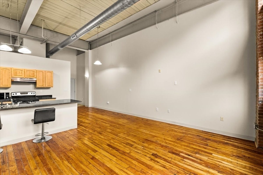 685 Social Street, Unit 215 Woonsocket, RI 02895 - Photo 30 of 40 a view of a kitchen with a sink and a microwave