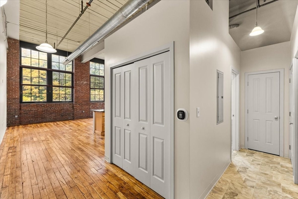 685 Social Street, Unit 215 Woonsocket, RI 02895 - Photo 38 of 40 a view of hallway with a bathtub and chandelier