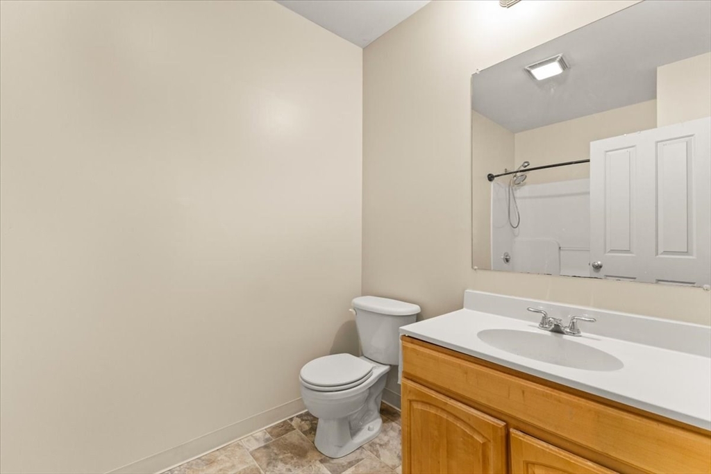 685 Social Street, Unit 215 Woonsocket, RI 02895 - Photo 39 of 40 a bathroom with a sink toilet and vanity