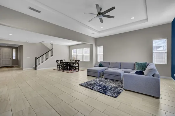 a living room with furniture and a chandelier