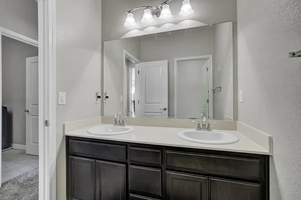 a bathroom with a sink vanity and a mirror