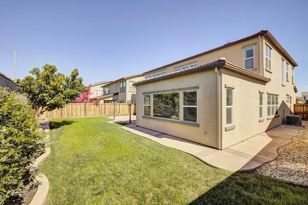 a view of a house with backyard and sitting area