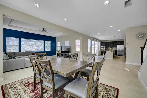 a dining room with furniture a window and a kitchen