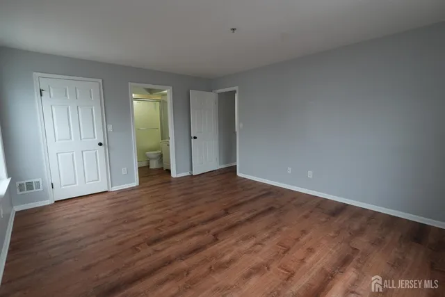 a view of walk in closet with empty racks