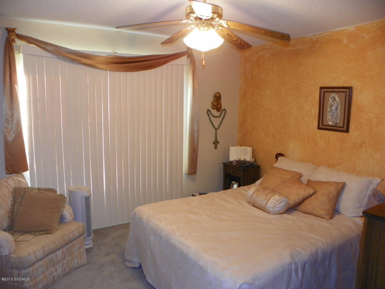 1103 Erie Court Rio Rico, AZ 85648 - Photo 16 of 16 a bedroom with a bed and a chandelier