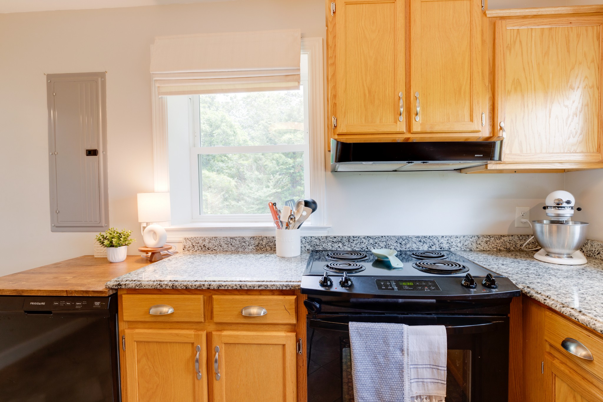 3020 Sylvia Road Dickson, TN 37055 - Photo 18 of 36 a kitchen with granite countertop a stove sink and cabinets
