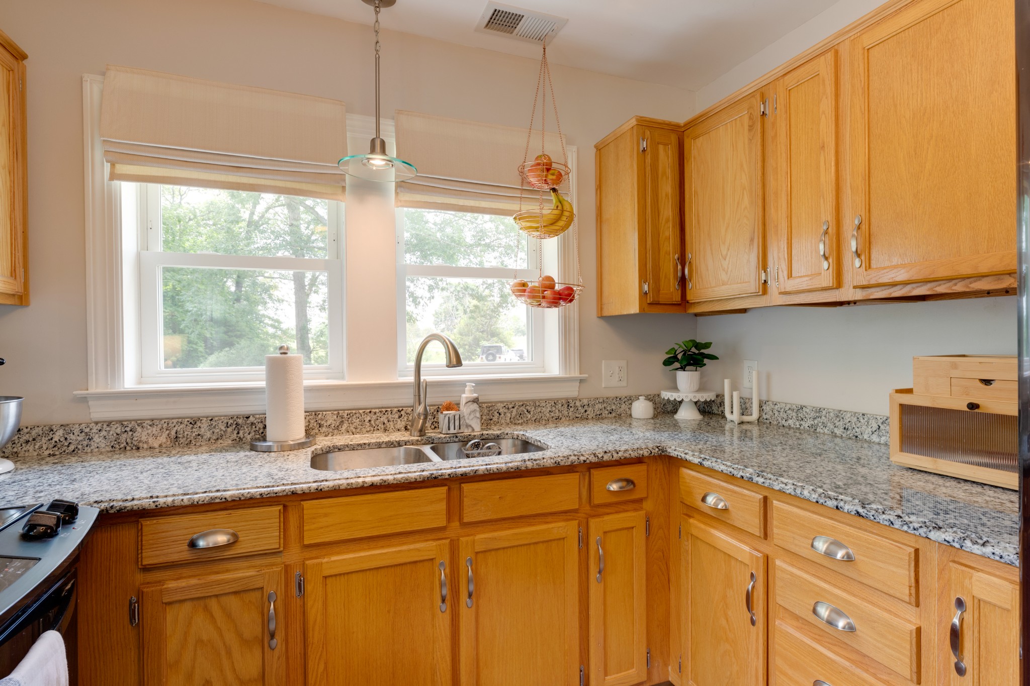 3020 Sylvia Road Dickson, TN 37055 - Photo 19 of 36 a kitchen with granite countertop a sink window and cabinets