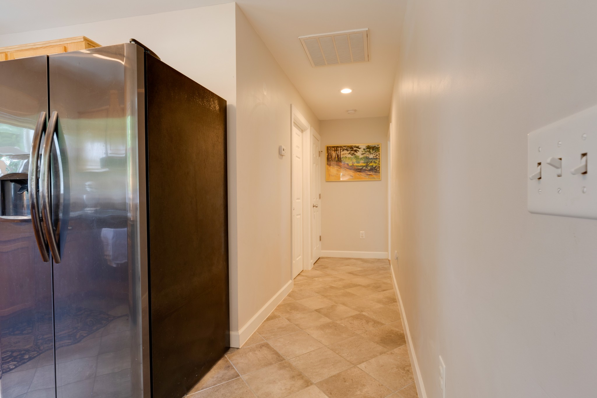 3020 Sylvia Road Dickson, TN 37055 - Photo 22 of 36 a view of a refrigerator in kitchen and an empty room