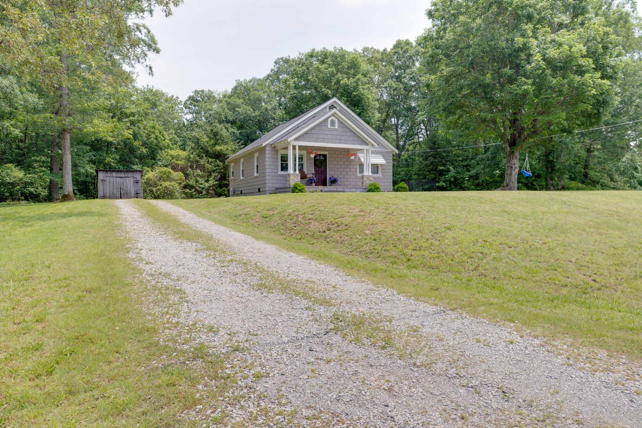 3020 Sylvia Road Dickson, TN 37055 - Photo 4 of 36 a front view of a house with a yard and trees