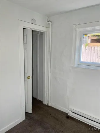 a view of a hallway with wooden floor and stairs