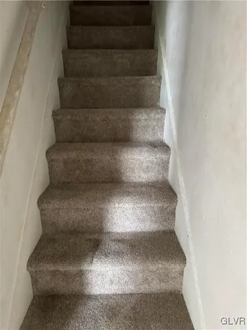 a view of an empty room and wooden floor