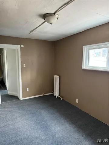 a bathroom with a toilet a sink and a window