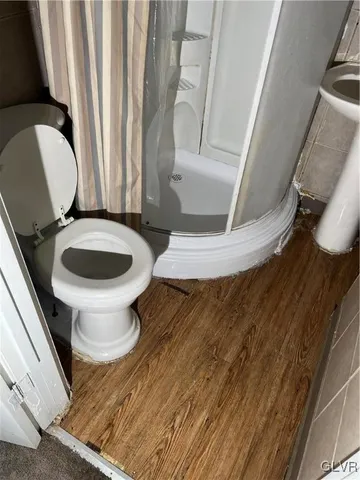 a bathroom with a toilet and a mirror