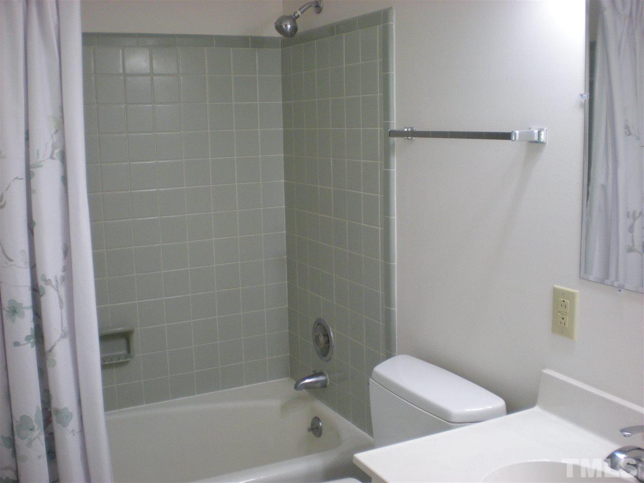 4108 Rockingham Drive Raleigh, NC 27609 - Photo 8 of 13 a bathroom with a toilet and shower
