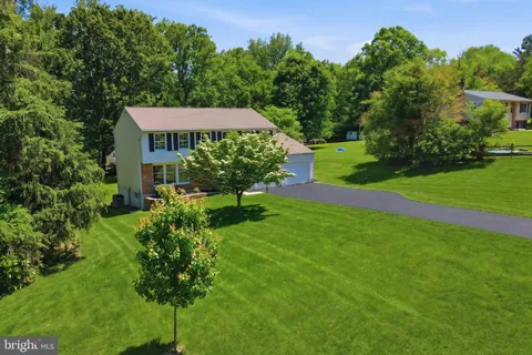 a view of a house with a yard and a garden