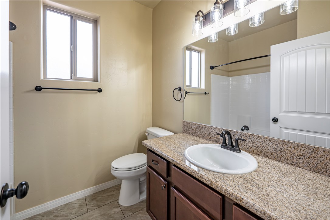 3546 North Kenneth Road Kingman, AZ 86409 - Photo 18 of 35 The bathroom features a vanity with a light-colored speckled countertop and a white oval sink with a dark-toned faucet
