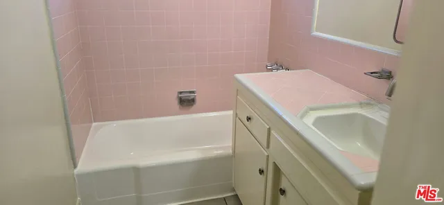 a bathroom with a tub sink and vanity