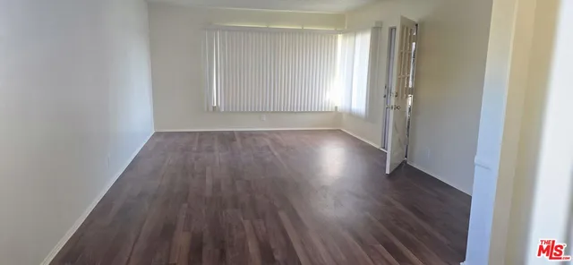a view of wooden floor and windows in a room