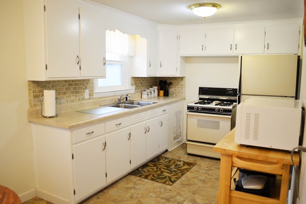 175 Brewster Street Springfield, MA 01119 - Photo 3 of 16 a kitchen with white cabinets and white appliances