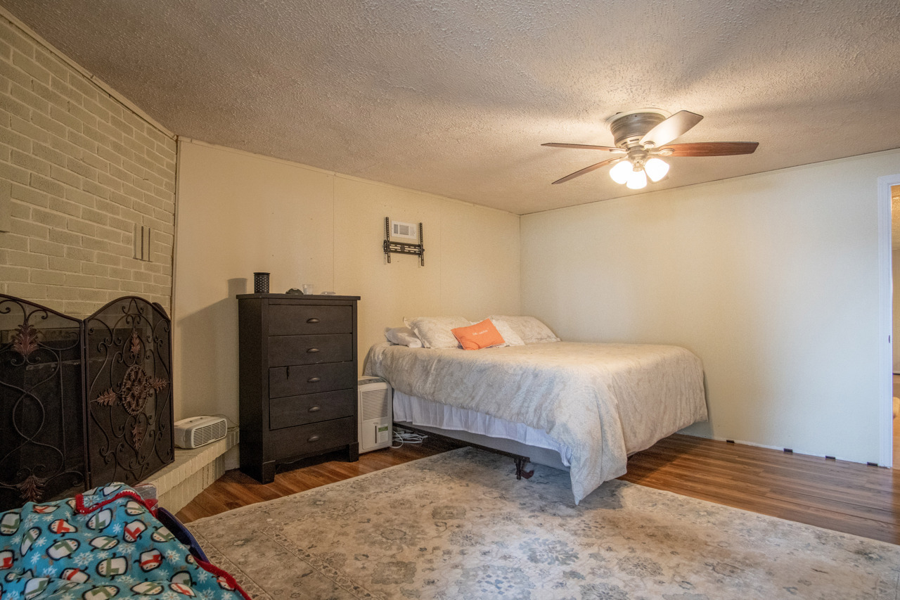 1910 Baintree Road Lake Summerset, IL 61019 - Photo 22 of 42 a bedroom with a bed and a chandelier