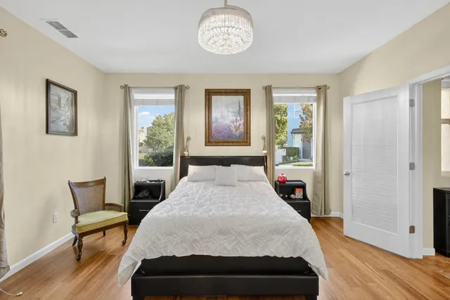 a bathroom with a granite countertop sink toilet and mirror