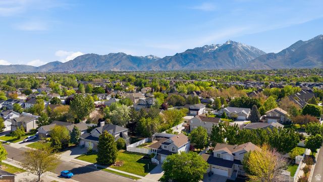 11189 Ohenry Road East Sandy, UT 84070 - Photo 33 of 44 Residential neighborhood featuring a variety of single-family homes with mature landscaping, paved streets, and a mountainous backdrop