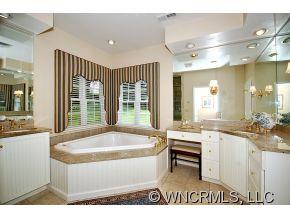 1964 County Road Lake Junaluska, NC 28745 - Photo 7 of 12 a spacious bathroom with a granite countertop sink and a large mirror