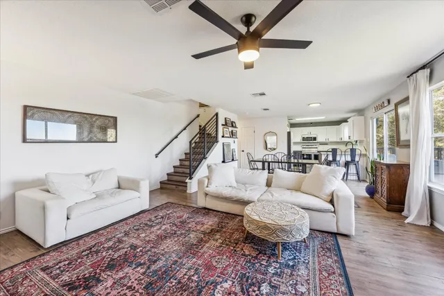 a living room with furniture and a chandelier