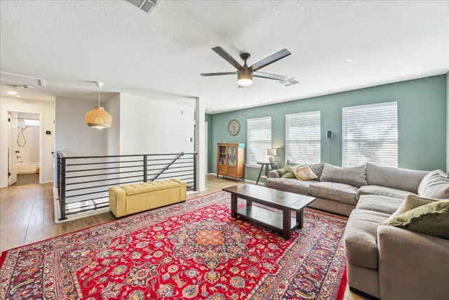a living room with furniture and a wooden floor