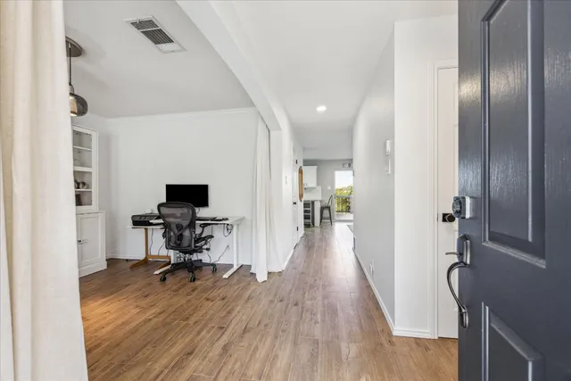 a view of a workspace with furniture and wooden floor