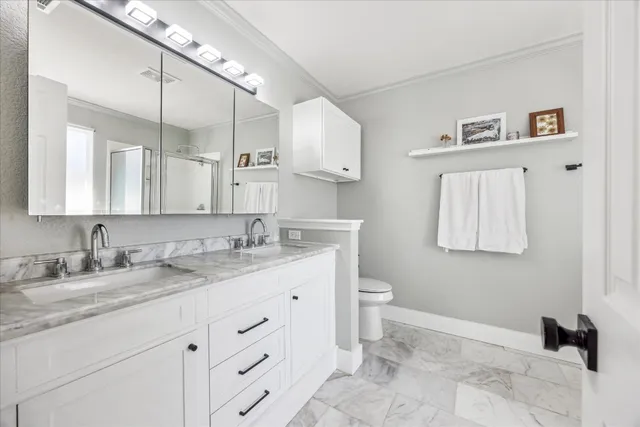 a bathroom with a double vanity sink mirror and