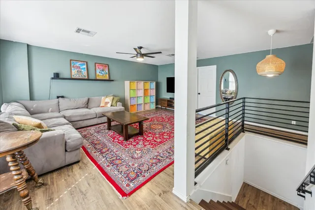 a living room with furniture and a wooden floor