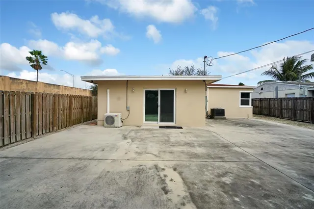 a view of a house with a backyard and a garage