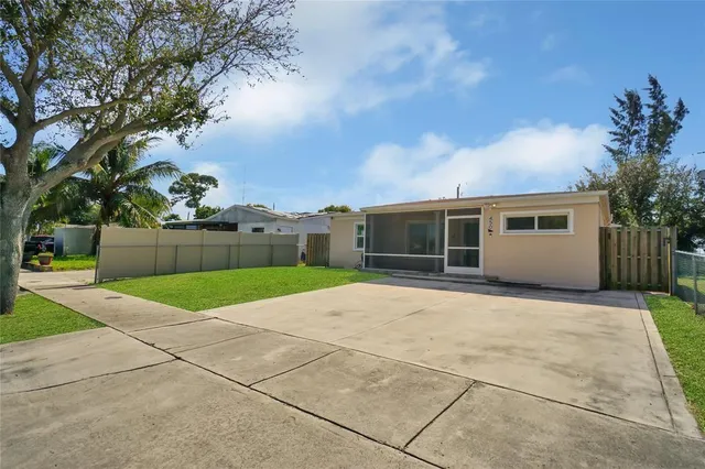 front view of a house with a yard and a garage