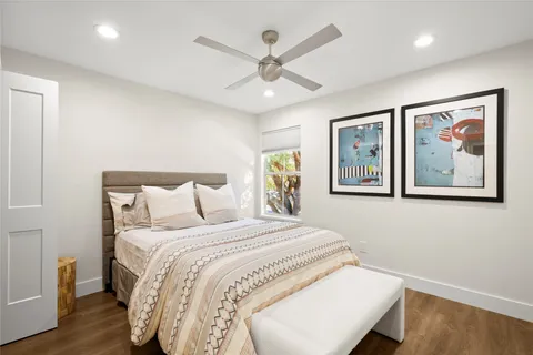 a bedroom with a large bed and a chandelier