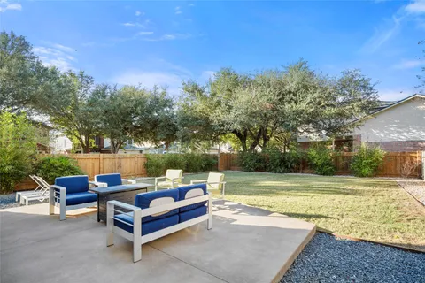 a view of a patio with chairs and a table
