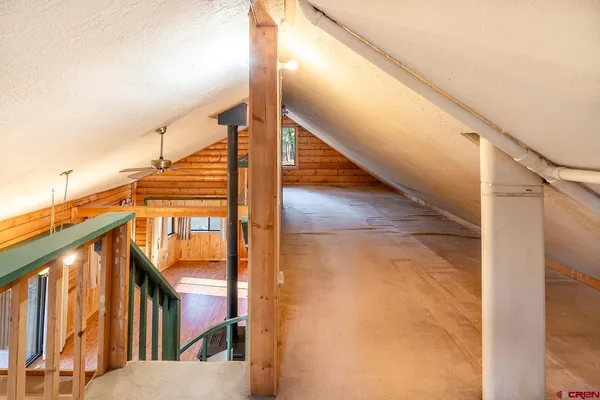a view of a hallway with stairs