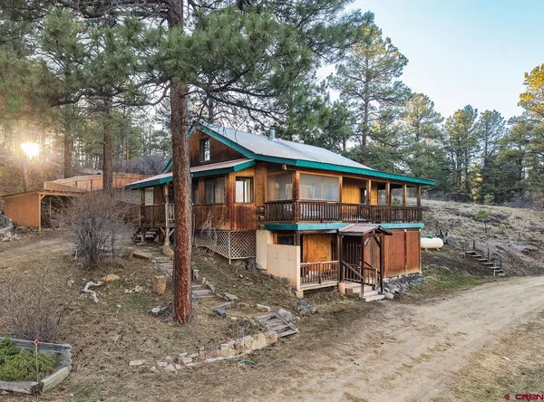 a view of a wooden house with a yard