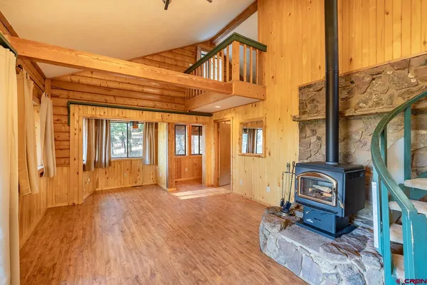 a view of an house with wooden floor and a ceiling fan