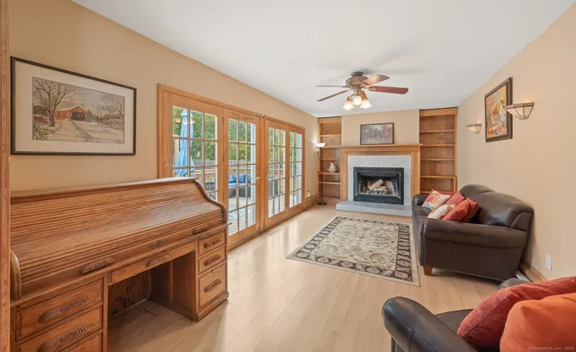 a living room with furniture a fireplace and a flat screen tv