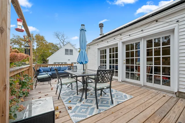 a view of a balcony with dining table and chairs with wooden floor