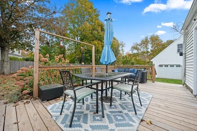 a view of a chairs and table on the wooden deck