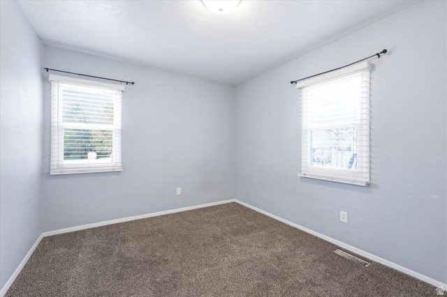 676 South 500 West Provo, UT 84601 - Photo 12 of 29 Spare room featuring dark carpet and healthy amount of natural light