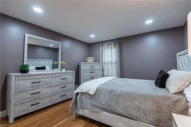 a bedroom with a bed and a dresser