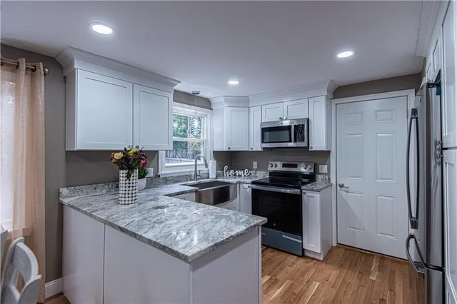 a kitchen with granite countertop stainless steel appliances and wooden cabinets