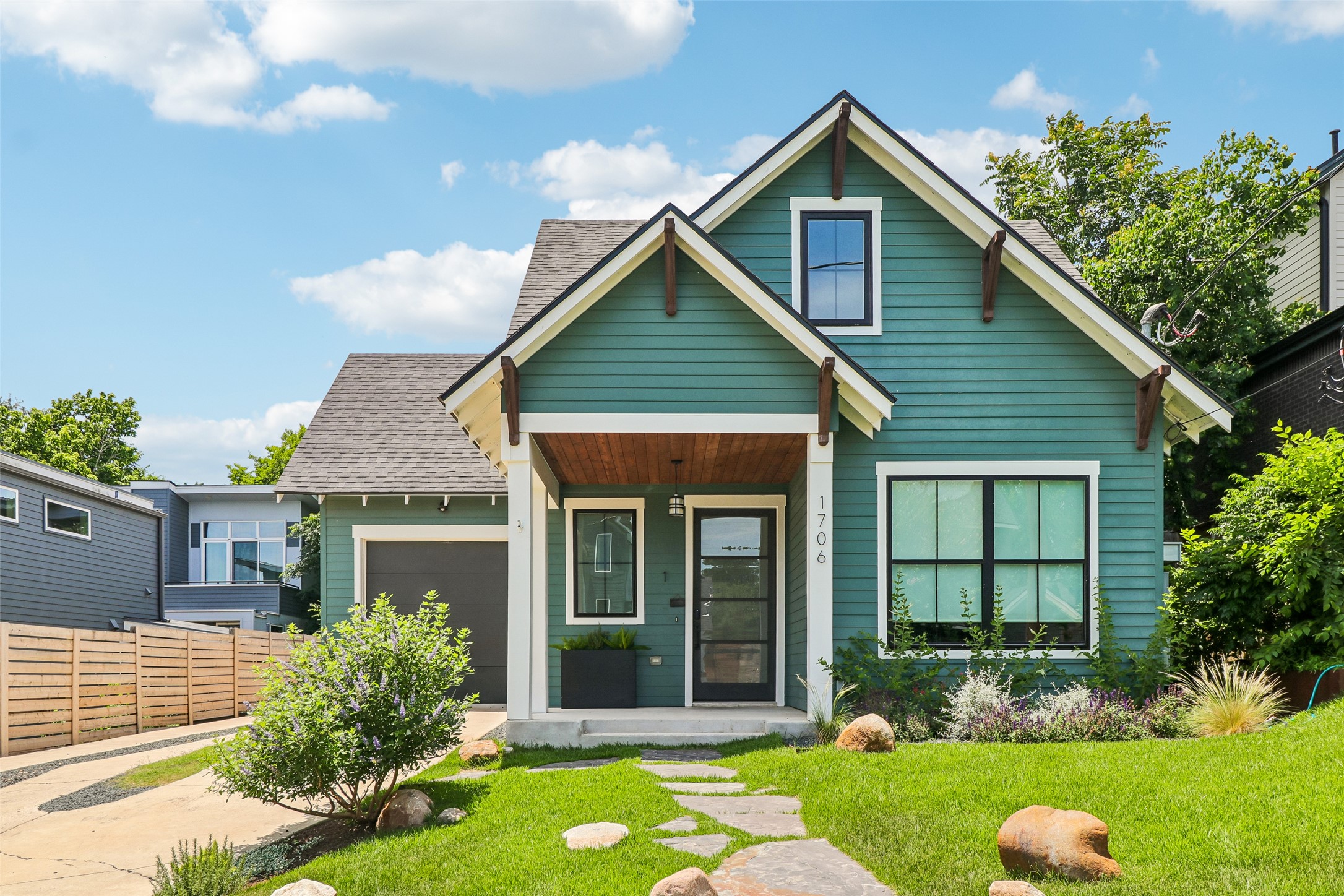 1706 Perez Street, Unit 1 Austin, TX 78721 - Photo 1 of 36 A charming teal-sided residence with a welcoming covered entry and verdant landscaping.