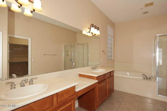 a spacious bathroom with a sink a large mirror and a bathtub