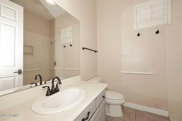 a bathroom with a sink a toilet and mirror