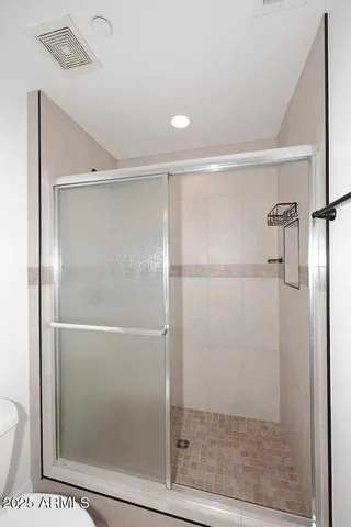 a bathroom with a glass shower door