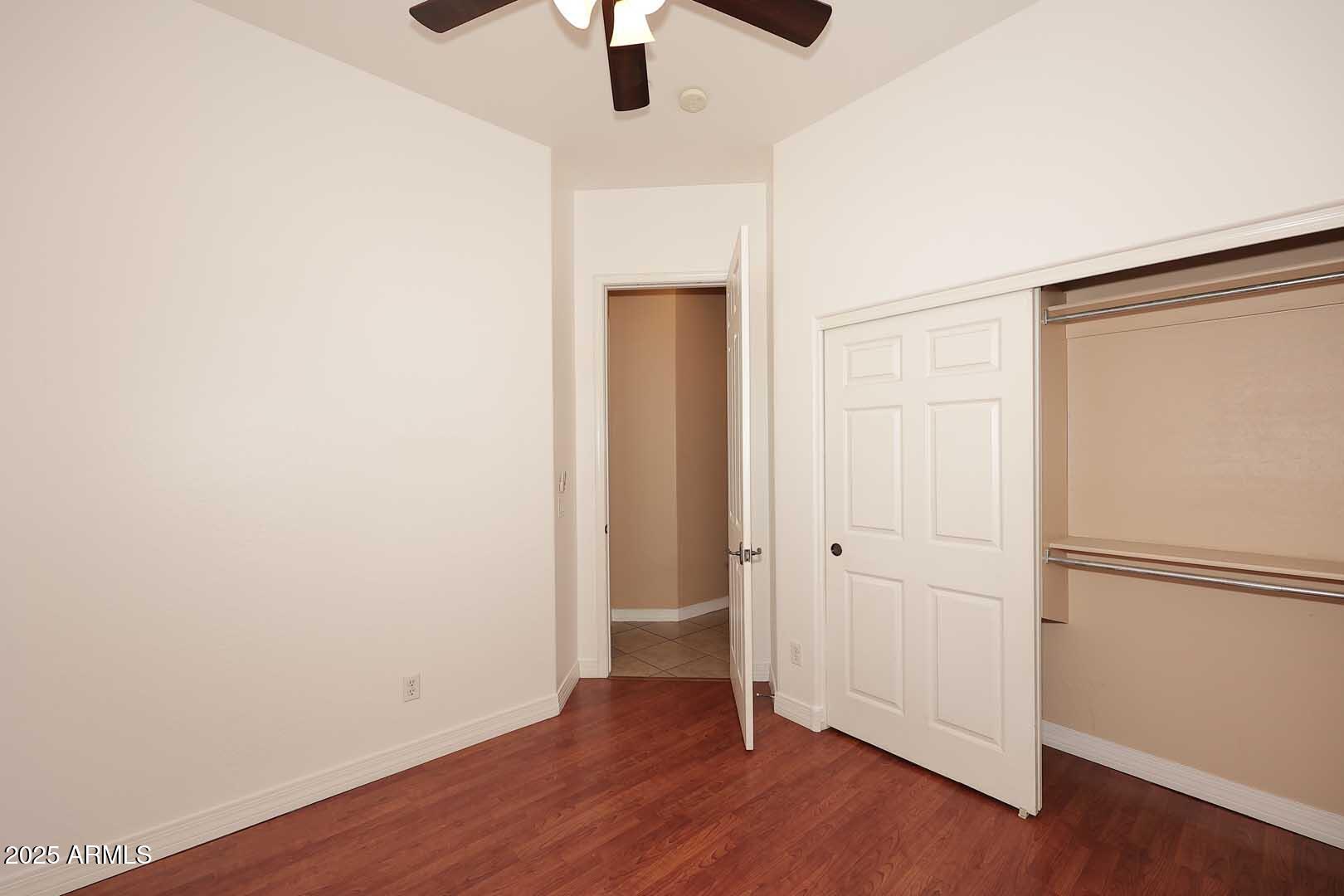 2007 East Topeka Drive Phoenix, AZ 85024 - Photo 27 of 34 an empty room with wooden floor and ceiling fan